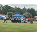 Long distance picture of people outside with a canopy for shade.