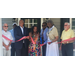 A group of people outside cutting the ribbon at the ceremony.