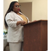 a woman speaking at a podium.