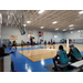 A group of people playing basketball on a court.