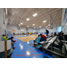 People playing basketball while a crowd watches.