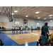 A group of people playing basketball.