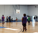 People standing on a basketball court.