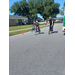 A boy and a fireman racing on bikes.