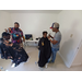 Barbers cutting two boys hair in a room.