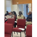 Students sit in chairs while listening.