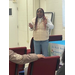 A woman talks in front of a crowd.