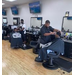 Barbers giving children haircuts. 