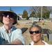  Two people with the community garden in the background. 
