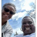  Two people smiling on a bright sunny day. 