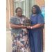  Crystal Price standing with another lady while holding an award. 