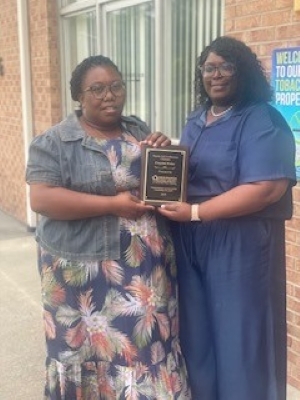 CrystalPricestandingwithanotherlady..jpg Crystal Price standing with another lady while holding an award.