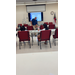  Two kids sit in chairs listening to a gentleman speak. 