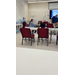  Two children sit and listen to two people speak. 
