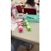  A closeup of a pink and green arts and crafts boat. 