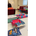  A closeup of a pink and blue boat art project. 