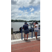 People standing out on a dock. 