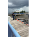  A man standing on the dock talking about the boat. 