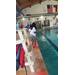  People standing around the pool. 