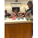  Three girls making boats out of pool noodles. 