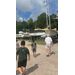  Four people walking through boat storage. 