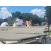  A mean talking to the kids about the motor of the boat. 