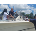  A man talking about the boat to kids. 