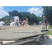  A group of kids sitting in a boat. 