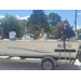  A man talks about the boat and kids sit and listen inside the boat. 