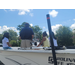  Two girls sitting in the drivers seat of the boat, one sitting on the side and the man talking. 