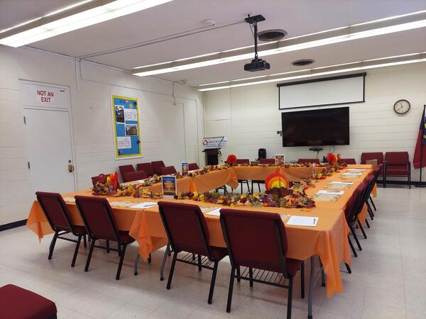 A table set up in a square decorated for fall.