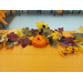  A small pumpkin and fall leaves on the table. 