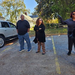  Two women and a man standing in the parking lot. 