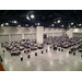  An aerial view of the room full of tables with people sitting around them. 