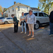  Three women stand in the parking lot. 