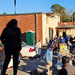  A woman standing and observing the food distribution. 