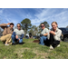  Four people smiling after planting trees. 