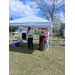  Two people speaking under a tent. 