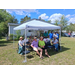  A group of people sitting under a tent. 