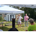  A man speaking with another man standing next to him. 
