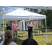  A person talking at a podium with a man standing nearby. 