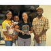  Lajoy smiling for a photo with her family. 