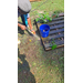  A person rinsing off potatoes before putting them in a bucket. 