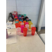  Different colored cups set out on a table. 