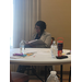  A woman sits at a table. 