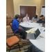  A group of people talking at a table. 