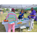 People chatting at a booth. 