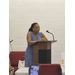 A woman speaks at a podium. 