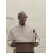  A man speaks at a podium. 