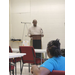  A man speaks to a room of people. 